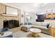 Cozy living room showcases brick fireplace, comfortable seating, and natural light streaming from kitchen entrance at 2805 Friendship Rd, Durham, NC 27705