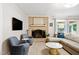 Inviting living room boasts a brick fireplace, plush seating, and a sliding door to the outdoors at 2805 Friendship Rd, Durham, NC 27705