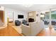 Open-concept living room features hardwood floors, brick fireplace, and access to the sunroom at 2805 Friendship Rd, Durham, NC 27705