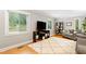 Bright living room with hardwood floors, neutral paint, and an oversized area rug at 2805 Friendship Rd, Durham, NC 27705