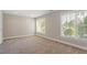 Bedroom with neutral carpet, paint and two windows allowing for ample natural light at 2822 Pickett Rd # 132, Durham, NC 27705