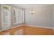 Dining room with hardwood floors, neutral paint, with an elegant hanging light fixture at 2822 Pickett Rd # 132, Durham, NC 27705