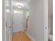 Entryway to a home with hardwood flooring, staircase, and access to a bathroom at 2822 Pickett Rd # 132, Durham, NC 27705