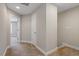 Hallway with carpeted floors and neutral walls, showcasing access to various rooms at 2822 Pickett Rd # 132, Durham, NC 27705