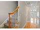View of staircase leading into a spacious hall with doors and wood flooring at 2822 Pickett Rd # 132, Durham, NC 27705
