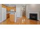 View of the kitchen with wood cabinets, white appliances, and living area with a fireplace at 2822 Pickett Rd # 132, Durham, NC 27705