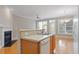 Bright kitchen with white dishwasher, stainless steel sink, and adjacent living room with fireplace at 2822 Pickett Rd # 132, Durham, NC 27705