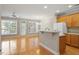 Open living and kitchen area featuring lots of natural light, hardwood floors and a ceiling fan at 2822 Pickett Rd # 132, Durham, NC 27705