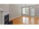 Living room featuring a fireplace, hardwood floors, a ceiling fan, and lots of sunlight at 2822 Pickett Rd # 132, Durham, NC 27705