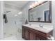 Well-lit bathroom with a double sink vanity and glass-enclosed shower, offering style and functionality at 301 Presque Isle Ln, Chapel Hill, NC 27514