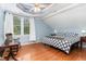 Bedroom boasts stylish decor, hardwood floors and a cozy reading nook for relaxation at 301 Presque Isle Ln, Chapel Hill, NC 27514