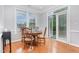 Bright dining area featuring a wood table, chairs, and a door leading to the deck at 301 Presque Isle Ln, Chapel Hill, NC 27514