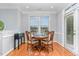 Bright dining area with hardwood floors, a round table, and access to a deck at 301 Presque Isle Ln, Chapel Hill, NC 27514