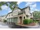 Charming townhouse with stone accents, green trim, and a private balcony, offers a sophisticated curb appeal at 301 Presque Isle Ln, Chapel Hill, NC 27514