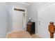 Bright foyer with tiled floor, coat closet, and decorative chest of drawers providing a welcoming entrance at 301 Presque Isle Ln, Chapel Hill, NC 27514
