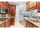 Kitchen featuring wood cabinets, granite countertops, and a dining area view at 301 Presque Isle Ln, Chapel Hill, NC 27514