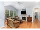 Cozy living room with vaulted ceiling, fireplace, hardwood floors, and sunlit windows, creating a warm atmosphere at 301 Presque Isle Ln, Chapel Hill, NC 27514