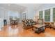 Open-concept living room with hardwood floors, dining area, and large windows that provide ample natural light at 301 Presque Isle Ln, Chapel Hill, NC 27514