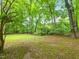 Lush and wooded backyard with plenty of trees and a shed at 310 Heidinger Dr, Cary, NC 27511