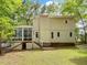 Expansive backyard featuring a sunroom addition and stairs leading up to the house at 310 Heidinger Dr, Cary, NC 27511