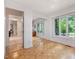 Sun-filled bedroom with hardwood floors, closet with mirrored doors, and a view of the garden at 310 Heidinger Dr, Cary, NC 27511