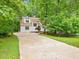 Beautiful home with a long driveway surrounded by lush greenery and mature trees at 310 Heidinger Dr, Cary, NC 27511