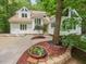 Charming home showcasing a landscaped front yard, tall trees, and bright exterior at 310 Heidinger Dr, Cary, NC 27511