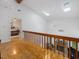 Upstairs hallway featuring hardwood floors, high ceilings, and views of the living room and bedroom at 310 Heidinger Dr, Cary, NC 27511