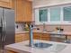 Close up on the kitchen, showcasing wooden cabinets, a stainless steel dishwasher, and ample counter space at 310 Heidinger Dr, Cary, NC 27511