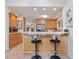 Open concept kitchen featuring modern barstools, wood cabinets, and a breakfast bar at 310 Heidinger Dr, Cary, NC 27511