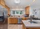 Bright kitchen features wood cabinets, stainless steel appliances, tile floors, and recessed lighting at 310 Heidinger Dr, Cary, NC 27511