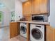 Laundry area features matching washer and dryer units, along with overhead cabinets and countertops at 310 Heidinger Dr, Cary, NC 27511