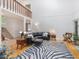 Open-concept living area with high ceilings, a leather sofa, and a unique zebra rug at 310 Heidinger Dr, Cary, NC 27511