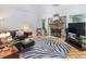 Spacious living room featuring a stone fireplace, plush seating, and a decorative zebra rug at 310 Heidinger Dr, Cary, NC 27511