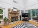 Bright living room with a stone fireplace, sliding glass doors, and a cozy zebra rug at 310 Heidinger Dr, Cary, NC 27511