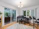 Bright music room with a piano, instruments, and a sliding glass door to a sunroom at 310 Heidinger Dr, Cary, NC 27511