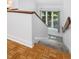 Carpeted stairway featuring hardwood flooring and a bright window at 310 Heidinger Dr, Cary, NC 27511