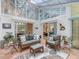 Relaxing sunroom with tile floors, comfortable seating, glass ceiling, and a leafy view of the outdoors at 310 Heidinger Dr, Cary, NC 27511