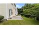 Exterior view of a home showcasing a concrete patio and grassy backyard at 3705 Rivermist Dr, Raleigh, NC 27610