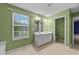 Bathroom featuring a double vanity, linoleum floor, and good lighting at 3705 Rivermist Dr, Raleigh, NC 27610