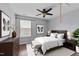 Well-lit bedroom featuring a ceiling fan, matching nightstands, and natural light at 3705 Rivermist Dr, Raleigh, NC 27610