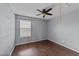 Bedroom with gray walls, wood floors, a ceiling fan, and a window at 3705 Rivermist Dr, Raleigh, NC 27610
