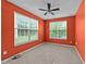 Bedroom with orange walls, carpet flooring, a ceiling fan, and two windows at 3705 Rivermist Dr, Raleigh, NC 27610