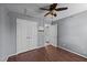 Bedroom with wood floors, ceiling fan, and double door closet at 3705 Rivermist Dr, Raleigh, NC 27610