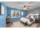Cozy bedroom featuring a large window, ceiling fan, and stylish decor at 3705 Rivermist Dr, Raleigh, NC 27610