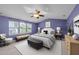 Comfortable bedroom features a vaulted ceiling, fan, and lots of natural light from the large windows at 3705 Rivermist Dr, Raleigh, NC 27610