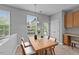 Bright dining area with natural light, a modern light fixture, and a built-in desk at 3705 Rivermist Dr, Raleigh, NC 27610
