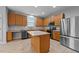 Modern kitchen with stainless steel appliances, an island, and updated countertops and tile flooring at 3705 Rivermist Dr, Raleigh, NC 27610
