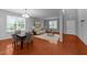 Spacious living room featuring hardwood floors and lots of natural light from large windows at 3705 Rivermist Dr, Raleigh, NC 27610