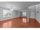 Bright living room with hardwood floors, neutral paint, large window, and an open floor plan at 3705 Rivermist Dr, Raleigh, NC 27610